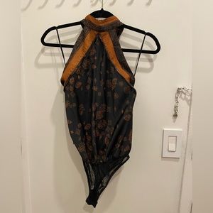 Free people black and orange bodysuit. Never worn. Backless. Size small